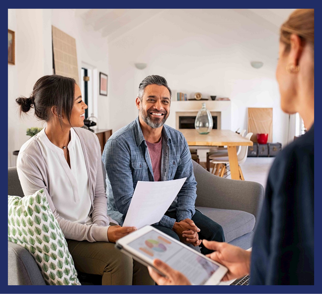 couple smiling at each other as they get a loan for their new home